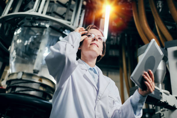 istock Thoughtful female engineer with tablet working at the factory 2160037785