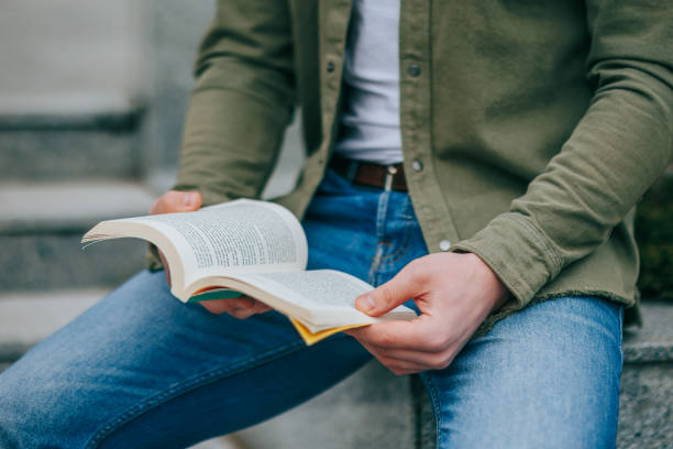 istock Knowledge is Power A Close-Up of Hands on a Book 2160038280