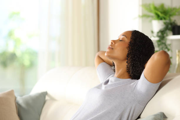 istock Black woman resting sitting on a sofa at home 2160038837