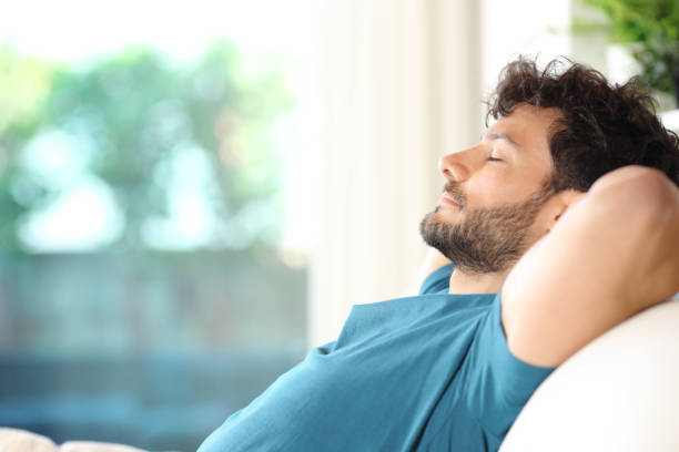 istock Serious man relaxing sitting on a sofa at home 2160039163