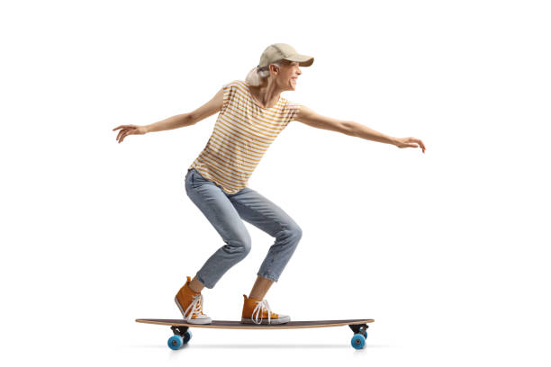 istock Cheerful young woman on a longboard 2160039711