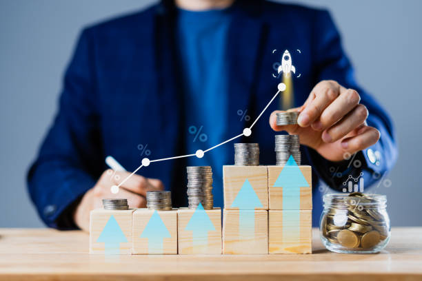 istock A man is putting coins on stack with a graph showing the growth of money 2160040636