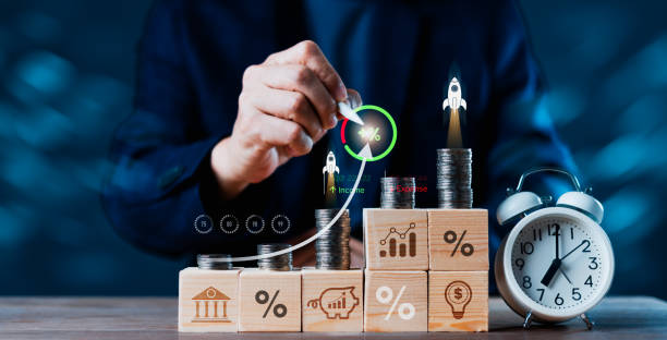 istock A man is drawing a rocket on a table with a clock and stacks of coins 2160040652