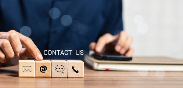 istock Website page contact us or e-mail marketing concept, Customer support hotline Contact us people connection. banner with copy space. cube wood with email, call phone, address, Chat message icons. 2160041163