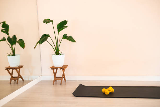 istock View of sport studio with a mat and dumbells 2160041191