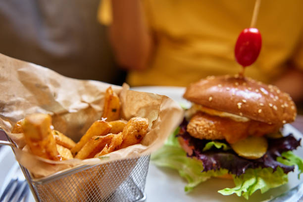 istock Delicious Chicken Burger and Crispy Fries in Restaurant 2160042156