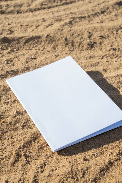 istock blank magazine mockup on sandy beach 2160042170