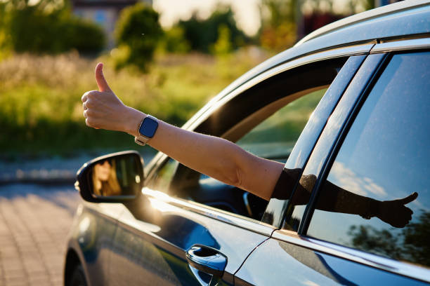 istock Woman Shows Thumbs Up Gesture from Car Window 2160043105