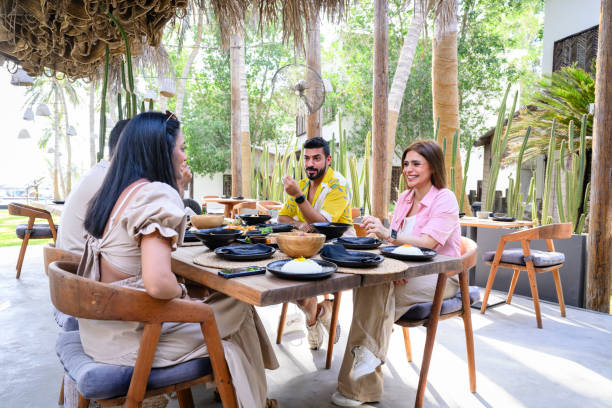 istock Saudi vacationers eating on resort patio 2160043851