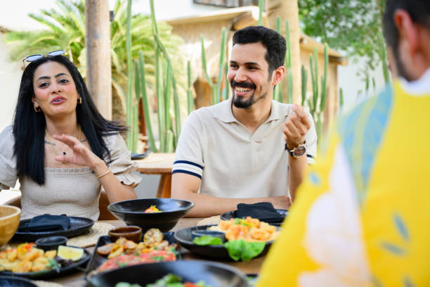 istock Saudi friends enjoying seafood tapas on vacation 2160043859