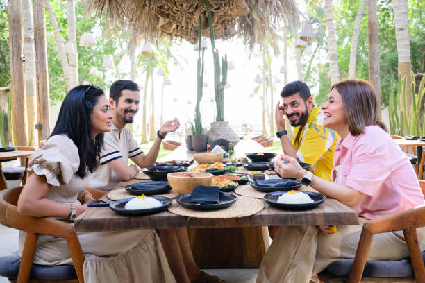 istock Relaxed vacationers talking, laughing, and eating 2160043885