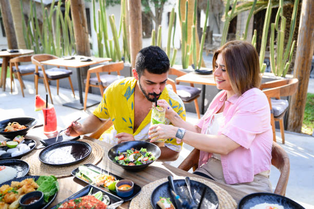 istock Vacationing couple sharing salad and mint lemonade 2160043913