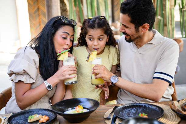 istock Young Saudi family enjoying resort refreshments 2160043921
