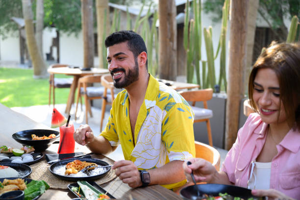 istock Saudi resort guests enjoying appetizers and fruit drinks 2160043971