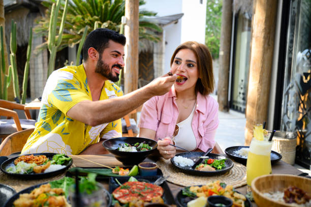 istock Saudi vacationers sharing appetizers 2160044114
