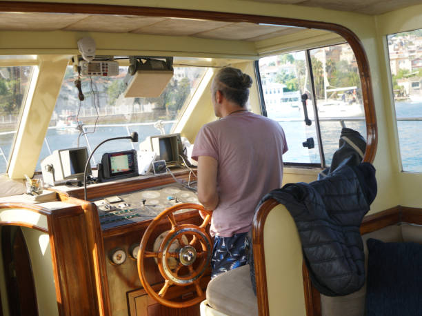 istock Man steering sailboat 2160044234