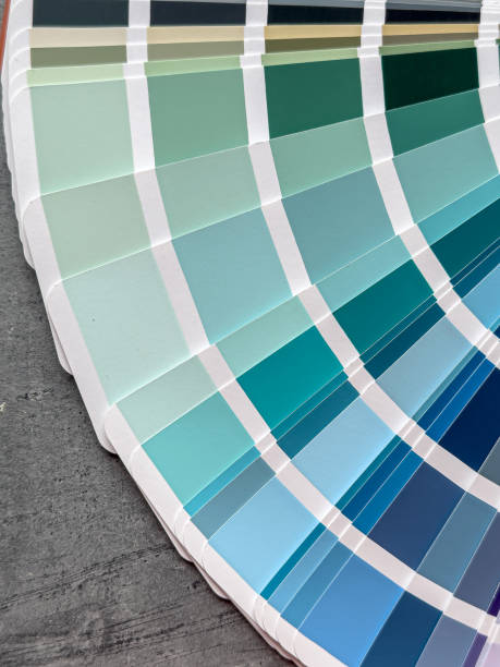 istock catalog of paints with different samples on grey desk.  Rainbow sample colors catalogue. 2160044290