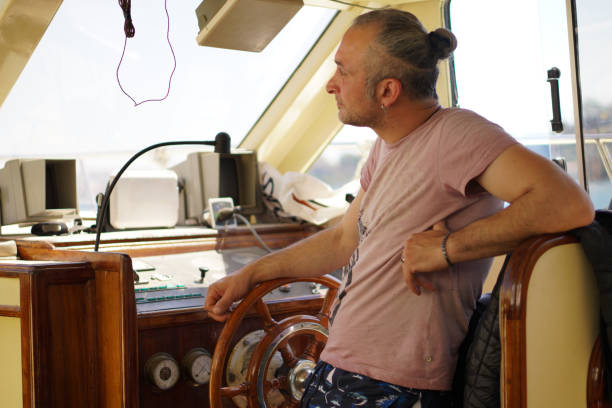 istock Man steering sailboat 2160044291