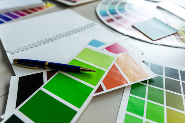 istock color palette guide for printing with brushes, blank notepad at office desk. Creative workplace 2160045384
