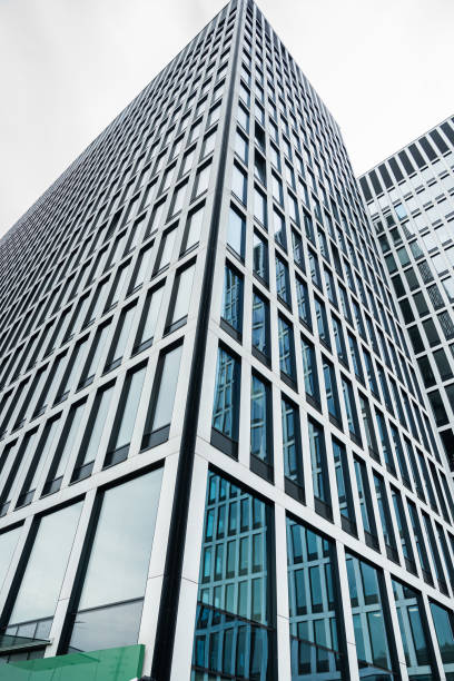istock Perspective angle view to modern glass building skyscrapers. Glass facade modern office building 2160045667