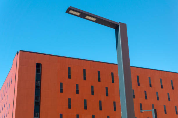 istock urban background: modern building with a lamppost against the blue sky 2160049135