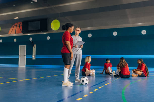 istock Coach giving instructions to a young female athlete. 2160050360