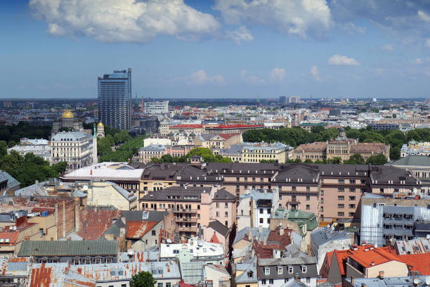 Riga, Latvia 06 05 2024 Cityscape with modern Radisson blu hotel behind the golden topped Riga Nativity of Christ Orthodox Cathedral.