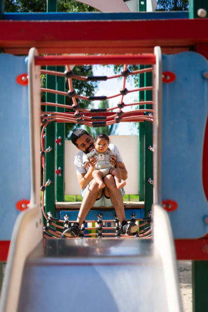 istock Latino single father with his baby in a playground 2160051862