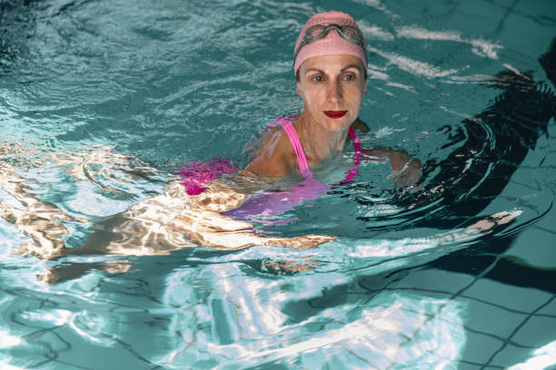 istock Female swimmer enjoying indoor pool, copy space. 2160052783