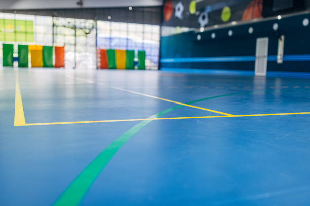 istock Empty blue indoor sports hall with vibrant markings 2160053448
