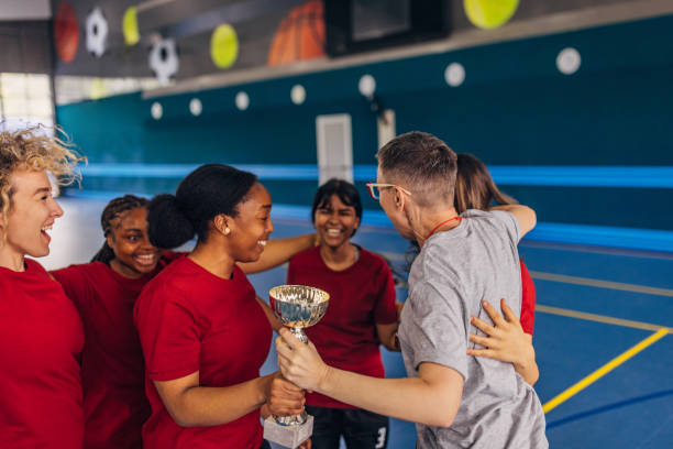 istock Excited sports team with coach celebrating a win 2160053570