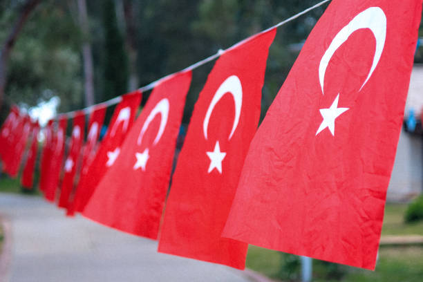 close up Turkish red flags hanging on a rope in a park. High quality photo