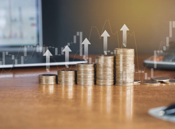 istock Up stack money coin with laptop computer and calculator in the background with trading graph and up arrow, Business and Financial concept. 2160056242