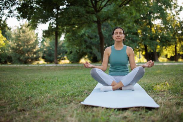 istock Woman doing yoga in a park 2160056760