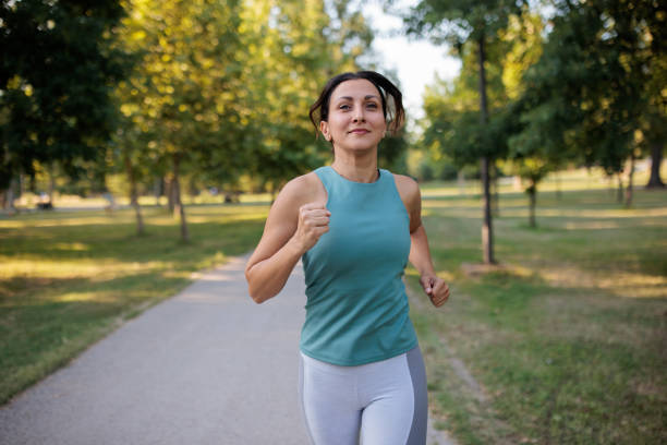 istock Woman running in a park 2160056995