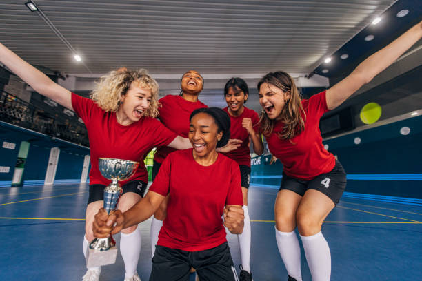 istock Happy winning team holding trophy celebrates indoors. 2160059507