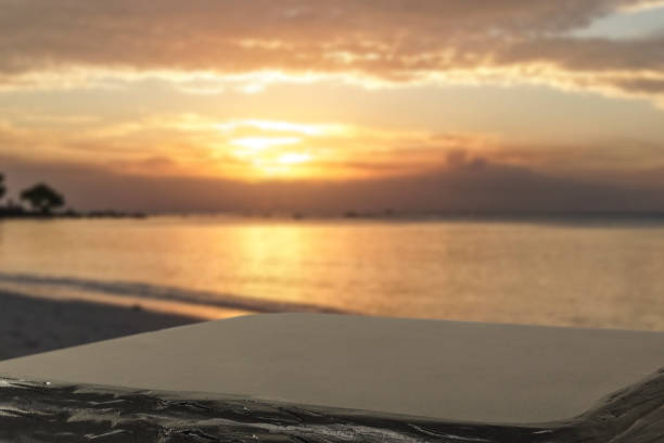 Empty black table with copy space and tropical summer beach and sea and sunset sky background.