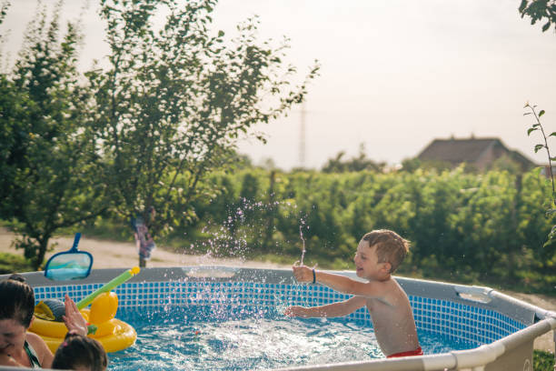 istock Woman with her children in  pool. 2160063773