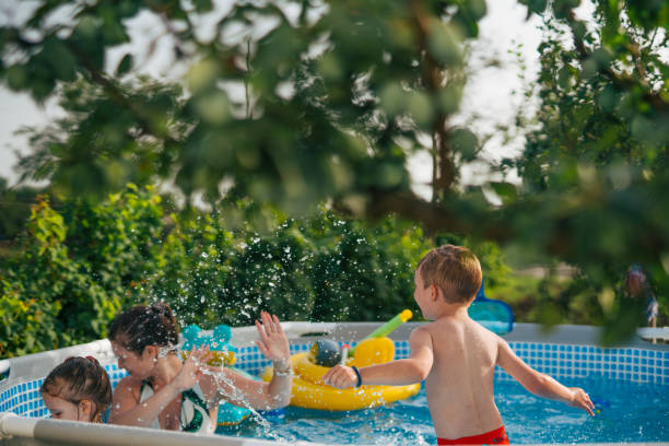 istock Woman with her children in  pool. 2160063914