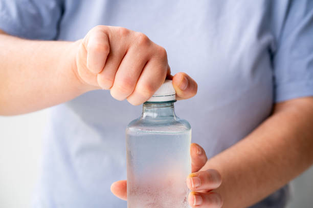 woman opening plastic bottle
