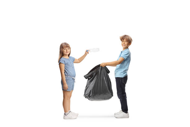 istock Boy holding a waste bag and girl throwing a plastic bottle 2160066117