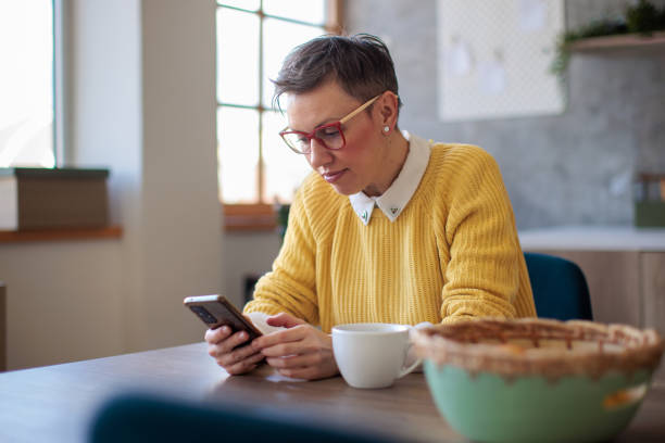 istock Woman in her forties using smart phone at home 2160066346