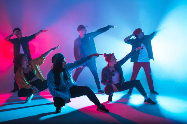 istock Diverse group of people dancing in studio with red and blue dual color light 2160066388