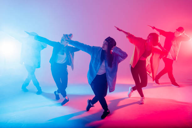 istock Diverse group of people dancing in studio with red and blue dual color light 2160066453