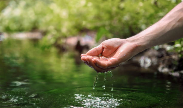 istock hand is holding a stream of water 2160067987