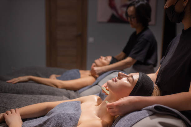 istock professional masseurs doctors doing anti-aging massage to clients 2160068541