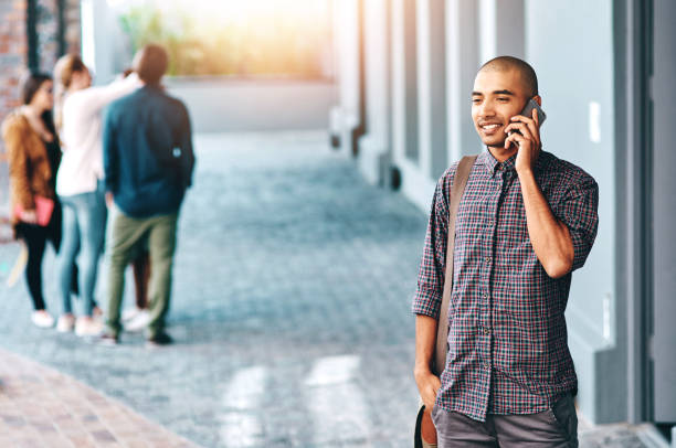 istock Phone call, university and man on campus for education, knowledge and studying for online chatting. College, academy and happy person on smartphone for social networking, conversation and connection 2160069555