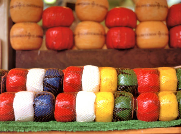 Edam cheese; a semi-hard cheese that originated in the Netherlands. It is traditionaly sold in flat-ended spheres with a pale yellow interior and a coat of red paraffin wax