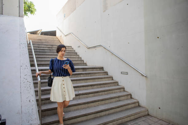 istock Woman using the mobile phone outdoors 2160073395