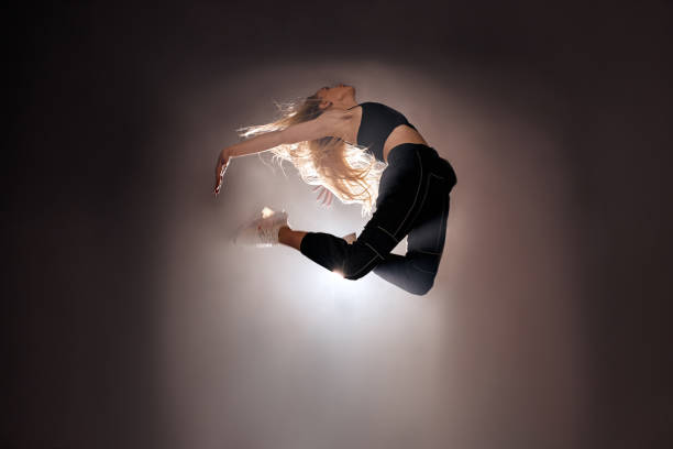 istock flexible female dancing contemporary dance in studio, jumping, active lifestyle 2160073825